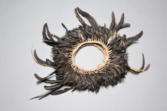 Diadema de plumas elaborado en fibra vegetal (mahute) y plumas negras de gallo.